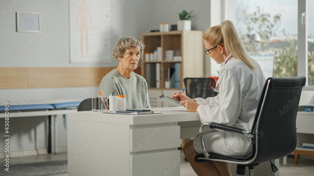 Female Family Doctor is Writing Down Senior Woman's Medical Issues During Consultation in a Health Clinic. Physician in Lab Coat Prescribing Drugs to Elderly Patient in Hospital Office. Female Family Doctor is Writing Down Senior Woman's Medical Issues During Consultation in a Health Clinic. Physician in Lab Coat Prescribing Drugs to Elderly Patient in Hospital Office.