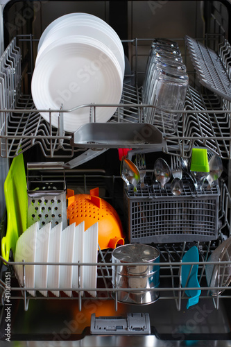 Dishwasher with clean dishes after cleaning with salt and detergent