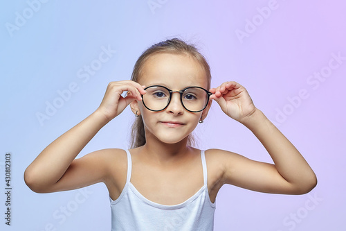 Little girl with glasses. photo session in the Studio