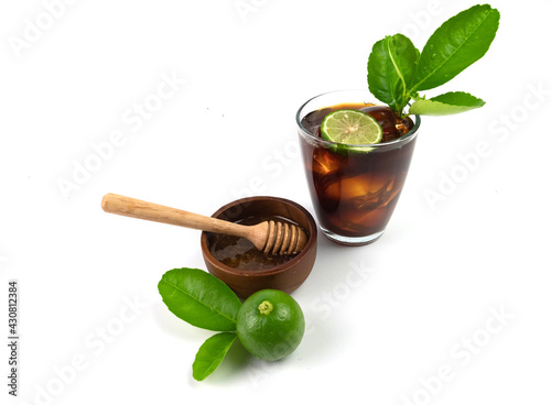 Iced black coffee with lemon and honey, isolated on white background.