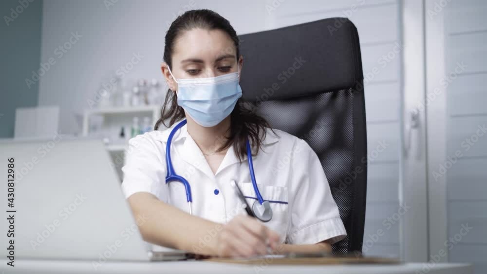 Physician working in clinic during pandemic Physician working in clinic during pandemic