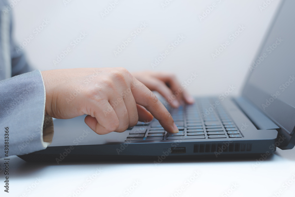close-up of business woman hand typing and using laptop keyboard for searching with technology networking on working and job on desk at work place or work at home. close-up of business woman hand typing and using laptop keyboard for searching with technology networking on working and job on desk at work place or work at home.