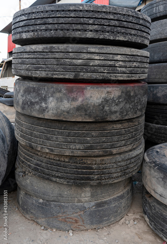 Old broken car tires stacked photo