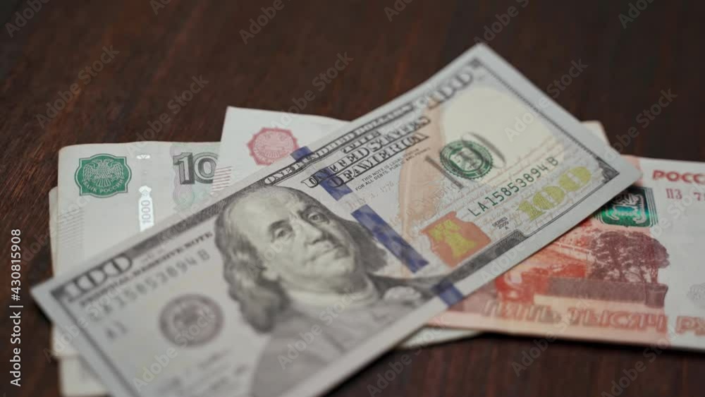 man counts money. Exchange of Russian and American currency at the bank. man counts money. Exchange of Russian and American currency at the bank.