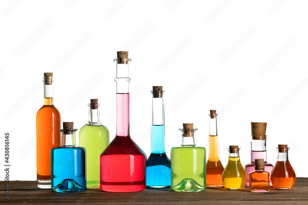 Old style glass bottles on white background. Various magic potions or colorful essential oils in the bottles on the table. Magic spell, potion and poison concept.
Old style glass bottles on white background. Various magic potions or colorful essential oils in the bottles on the table. Magic spell, potion and poison concept.