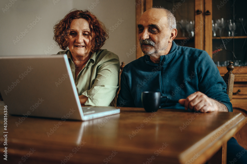 Senior couple using a laptop for a video call Senior couple using a laptop for a video call