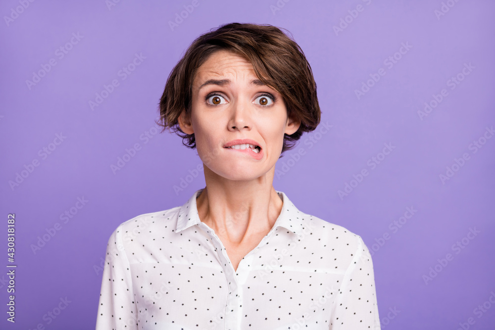 Portrait of attractive worried unsure uncertain brown-haired girl manager biting lip isolated over bright violet purple color background - obrazy, fototapety, plakaty 