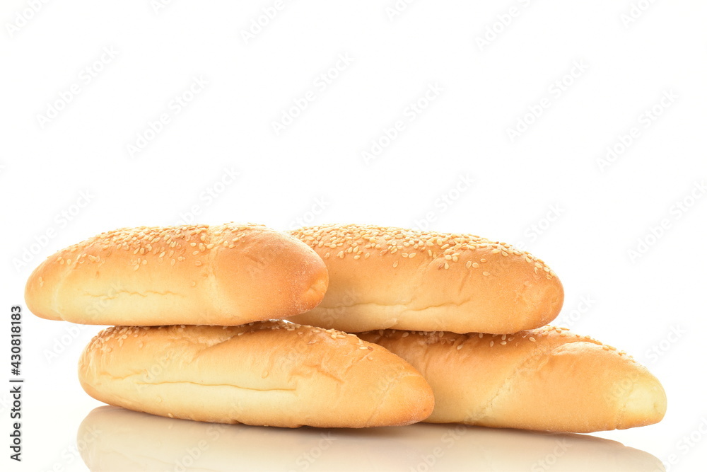 Several fragrant bagels sprinkled with sesame seeds, close-up, isolated on white.