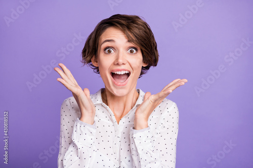Portrait of attractive amazed cheerful girl executive manager having fun great news isolated over bright violet purple color background