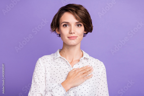 Portrait of attractive sincere girl executive manager oath touching heart isolated over bright violet purple color background