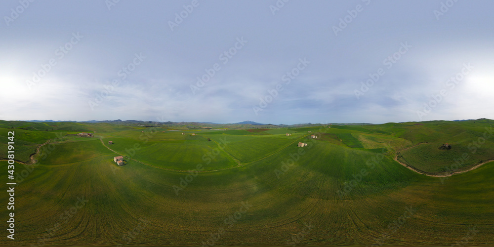 Naklejka premium 360 degree aerial photo of wheat fields with farms in the heart of Sicily. Etna view. Sicilian green wheat.