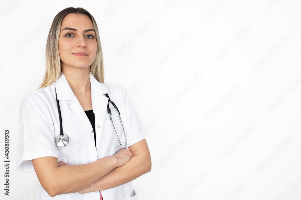 Beautiful young female medical doctor is looking at camera and smiling Shot of a female doctor standing confidently with her arms crossed. Beautiful young female medical doctor is looking at camera and smiling Shot of a female doctor standing confidently with her arms crossed.