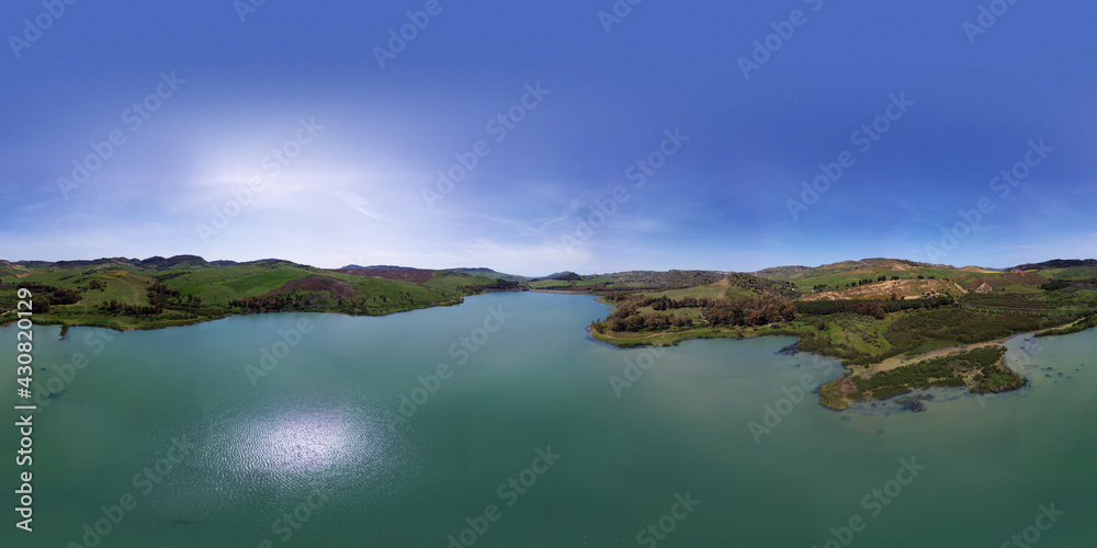 360 degree aerial photo of Villarosa lake in Sicily. Immersed in a luxuriant nature and destination of numerous migratory birds. Relax around the lake. Nature in Sicily.