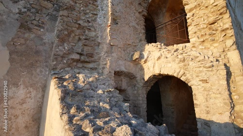 Ruins of Castello della Valle overlooking the Tyrrhenian Sea at sunset, an old castle in Fiumefreddo Bruzio, Calabria, south Italy photo