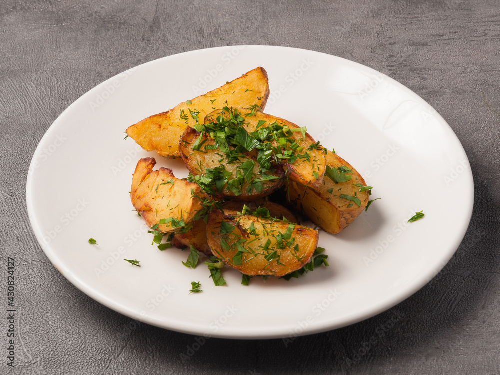 potato slices with herbs on a white plate potato slices with herbs on a white plate