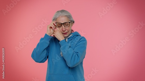 Billede på lærred Upset disappointed senior old granny gray-haired woman wipes tears and cries from despair, being sad because of unfair things