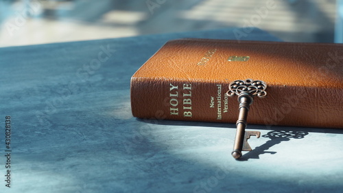 Key and bible on grey marble. Concept bible is key of life.  Key  Salvation is in bible.  Invaluable of God's word. Bible key success.  Christianity background.