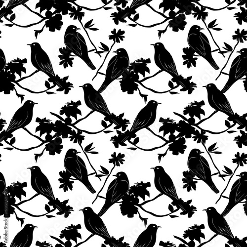 Seamless pattern with silhouette of birds sitting on twigs. Vector background with branches of tree. © Vladimir