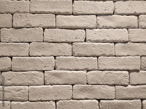 White painted brick wall in fluorescent lighting. Concept   Interior design   Architect material   Architecture background.