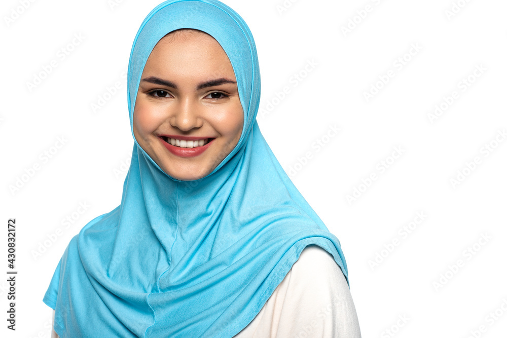 Muslim woman in hijab smiling at camera isolated on white Muslim woman in hijab smiling at camera isolated on white