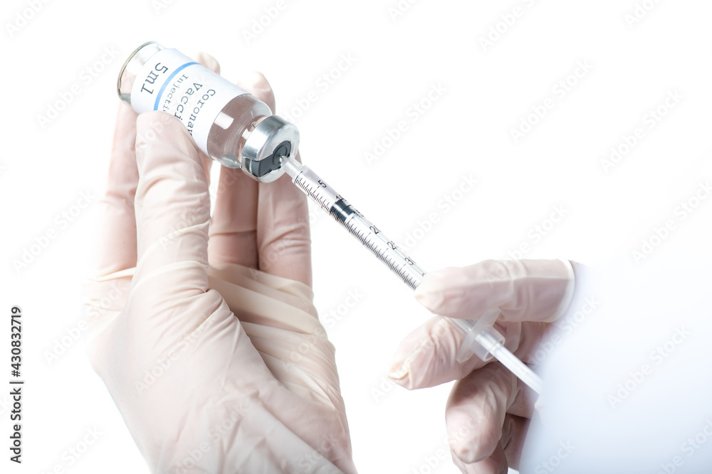 Cropped view of doctor picking up vaccine in syringe isolated on white Cropped view of doctor picking up vaccine in syringe isolated on white