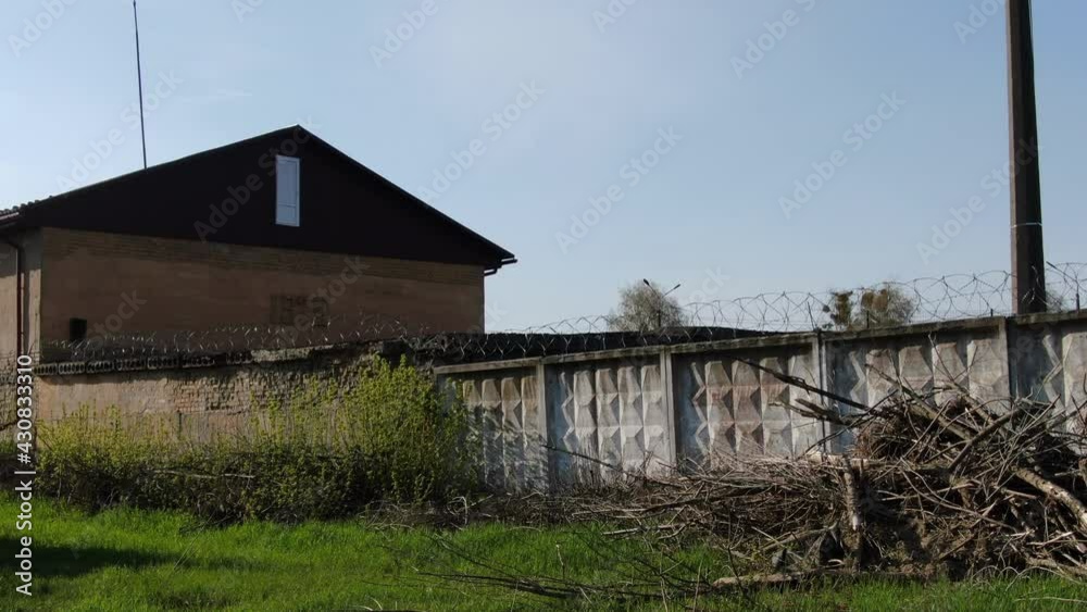 Old prison behind a barbed wire fence