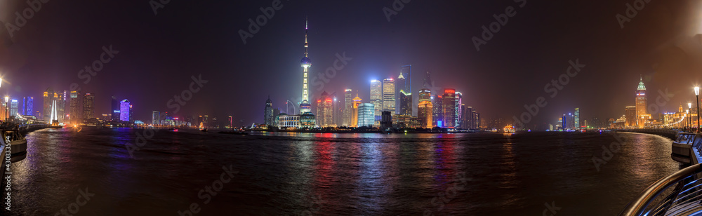 Panoramic view of the skyline of Shanghai's Pudong district from the famous promenade the Bund in the evening