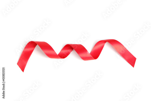 Red ribbon twisted in a spiral on a white background.