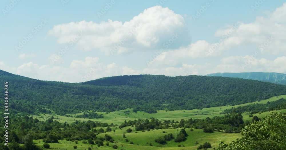 Timelapse of the clouds in mountain meadow and woodland, Lika region of Croatia Timelapse of the clouds in mountain meadow and woodland, Lika region of Croatia