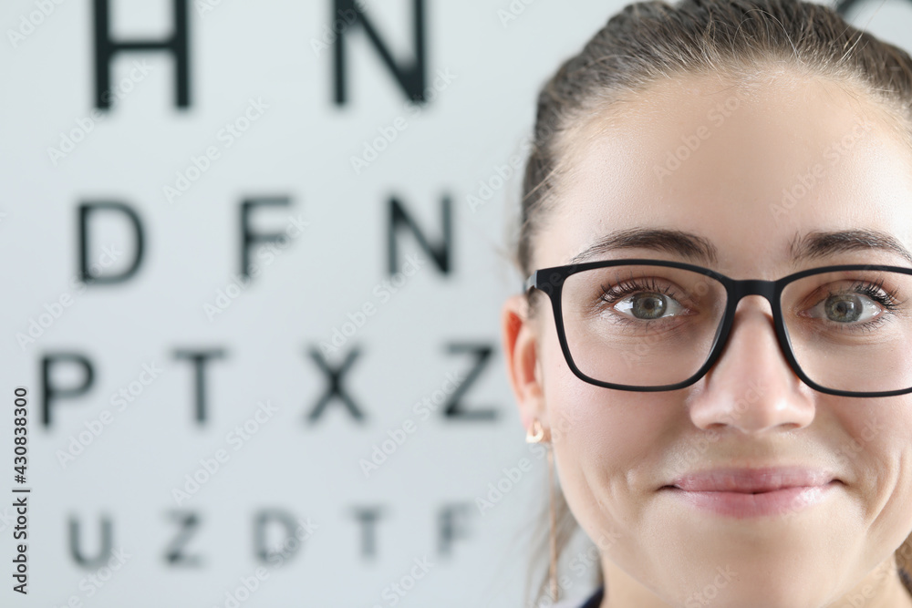 Portrait of woman with glasses on background of ophthalmic table Portrait of woman with glasses on background of ophthalmic table