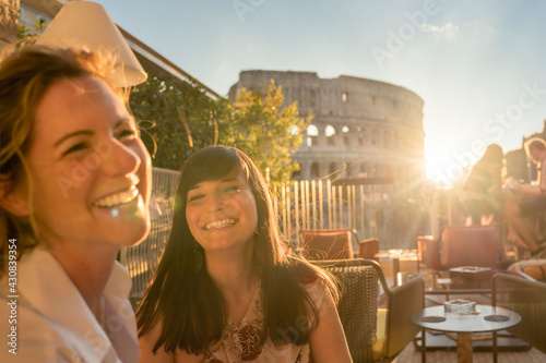 Two smiling women at sunset in Rome, Italy
