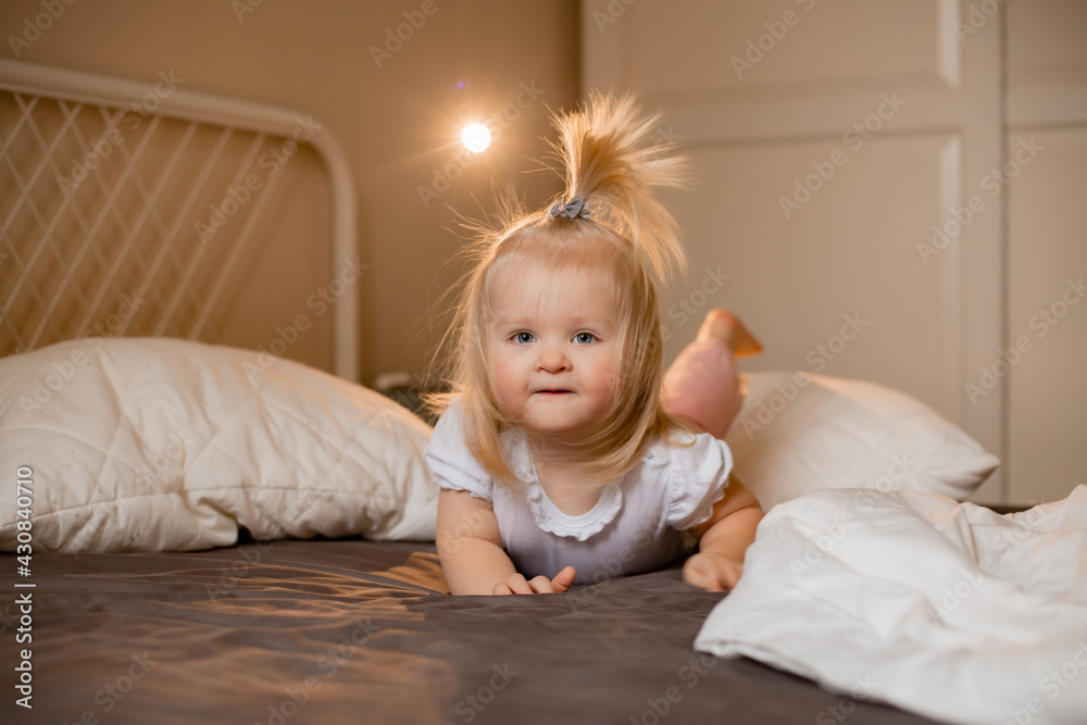 Fototapeta premium Happy little girl pragy in bed at home
