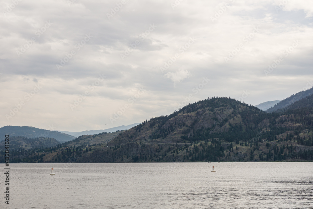 beautiful Okanagan lake with blue sky and white clouds summer day.