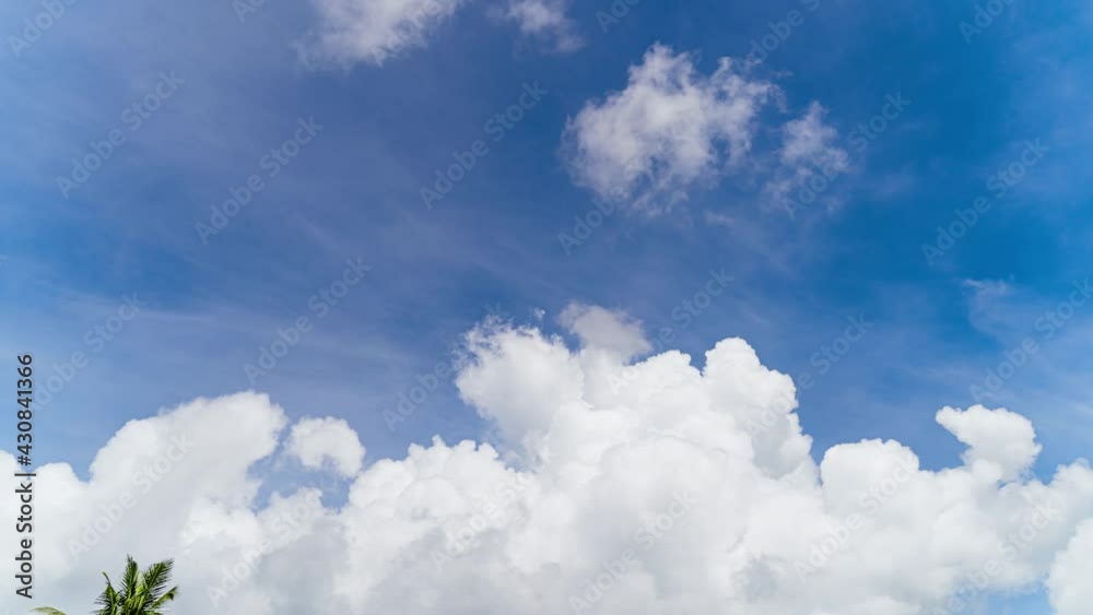 Blue sky white clouds. Puffy fluffy white clouds. Summer blue sky time lapse. Nature weather blue sky. White clouds background. Cloud time lapse nature background in Phuket Thailand. Blue sky white clouds. Puffy fluffy white clouds. Summer blue sky time lapse. Nature weather blue sky. White clouds background. Cloud time lapse nature background in Phuket Thailand.