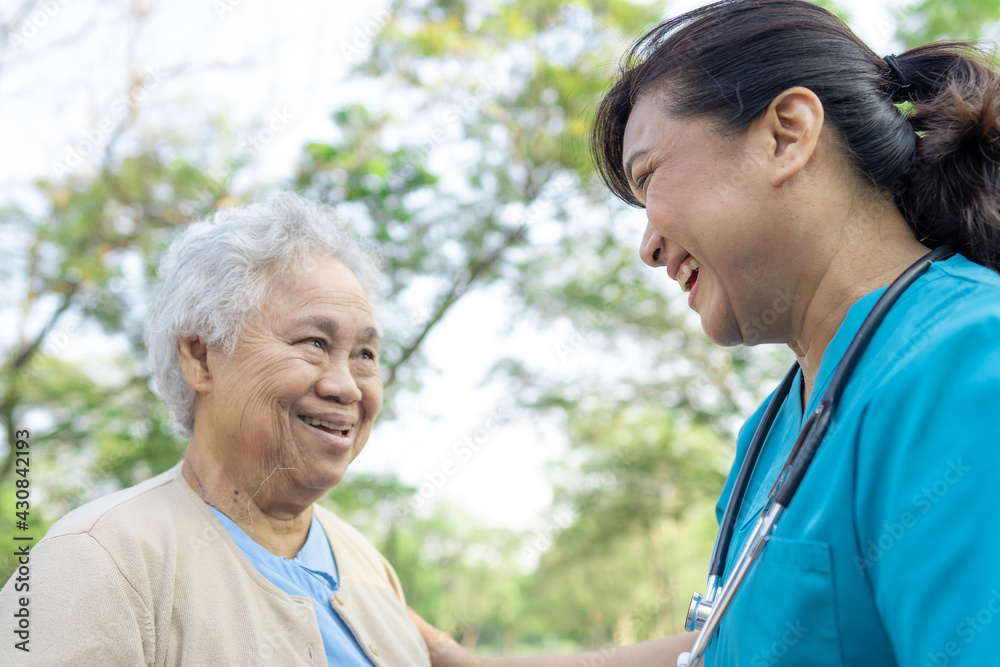 Doctor help and care Asian senior or elderly old lady woman with strong health while walking at park in happy fresh holiday. Doctor help and care Asian senior or elderly old lady woman with strong health while walking at park in happy fresh holiday.