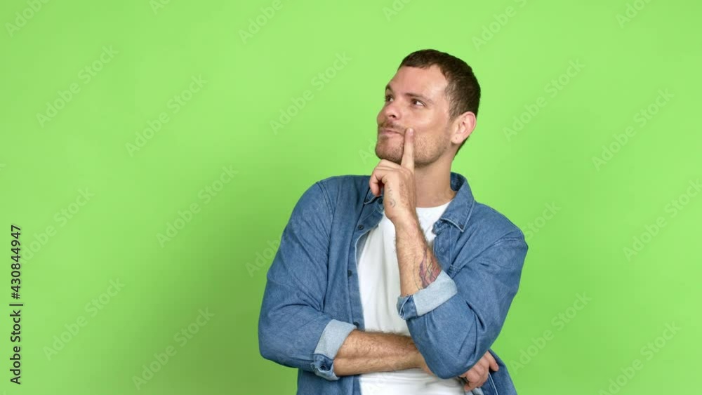 Brazilian handsome man standing and thinking an idea pointing the finger up over isolated background Brazilian handsome man standing and thinking an idea pointing the finger up over isolated background