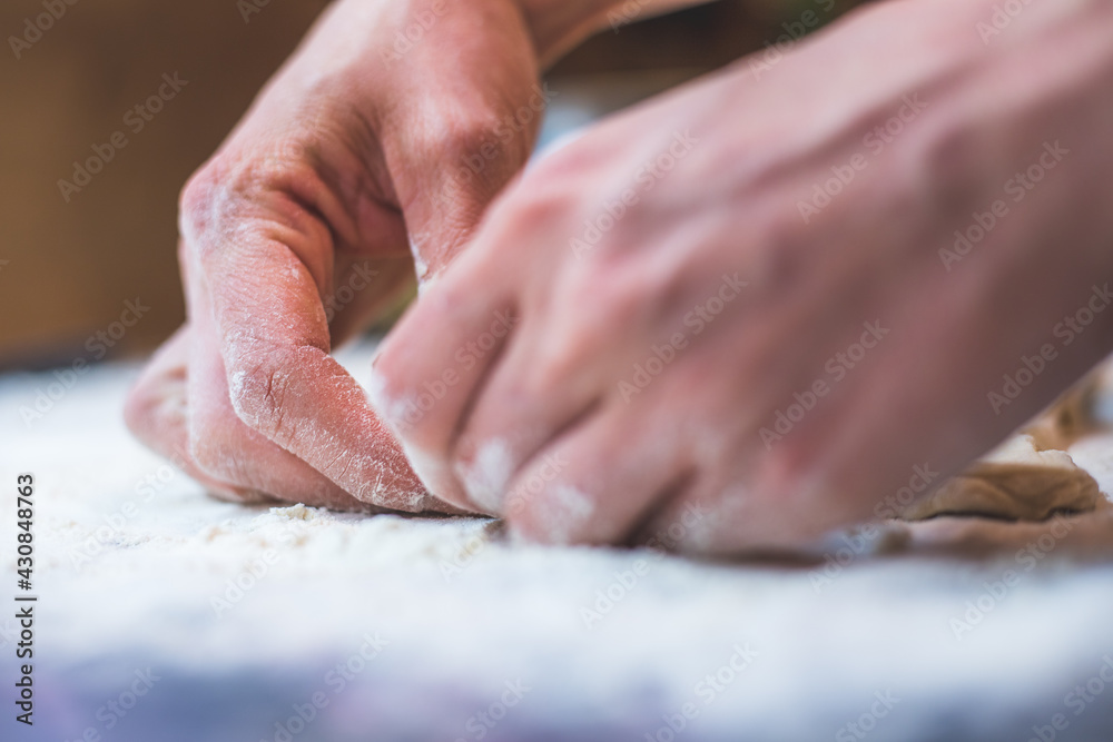 Rolling traditional dough in the kitchen, close up