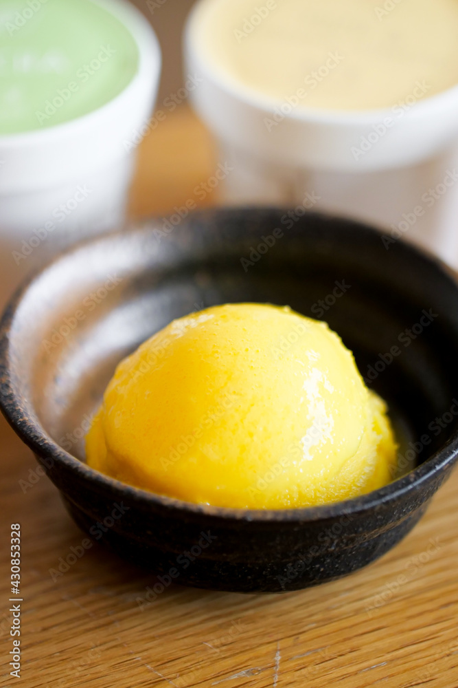 Yuzu and mandarin orange Italy Gelato ice cream iced dessert in japanese style cup. Yuzu and mandarin orange Italy Gelato ice cream iced dessert in japanese style cup.