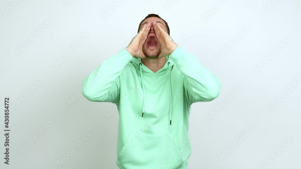 Brazilian handsome man shouting and announcing something over isolated background
