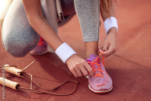 Runner tying jogging shoes