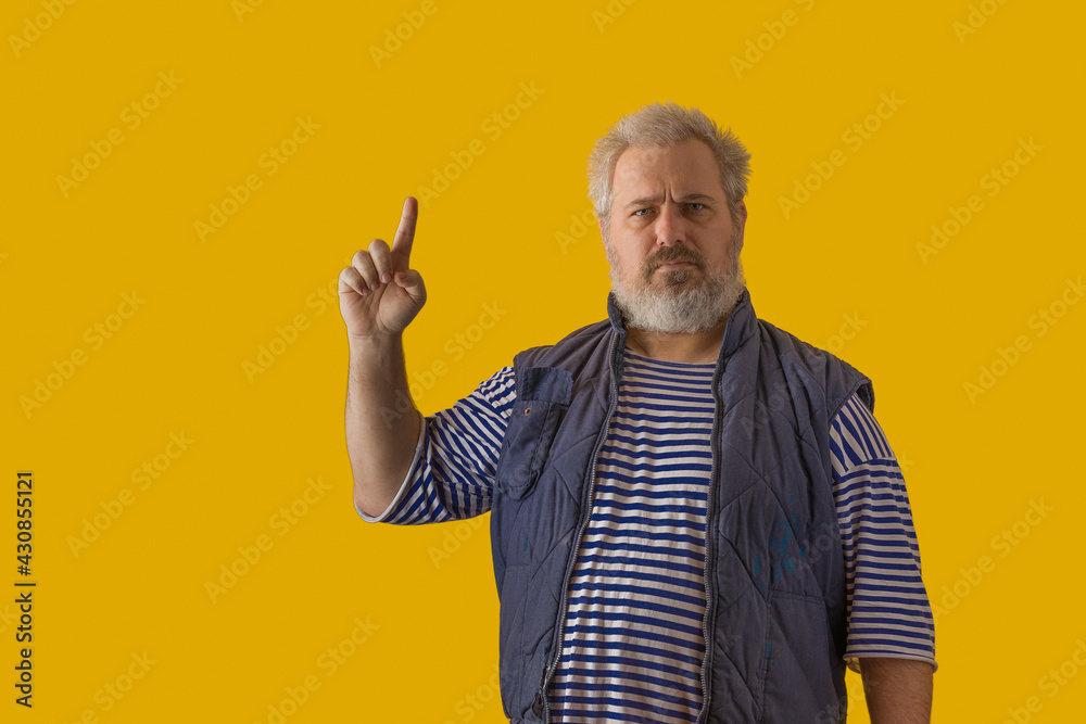 A man with a gray beard, gray hair, wearing a sailor shirt and sleeveless jacket, shows the symbol A man with a gray beard, gray hair, wearing a sailor shirt and sleeveless jacket, shows the symbol
