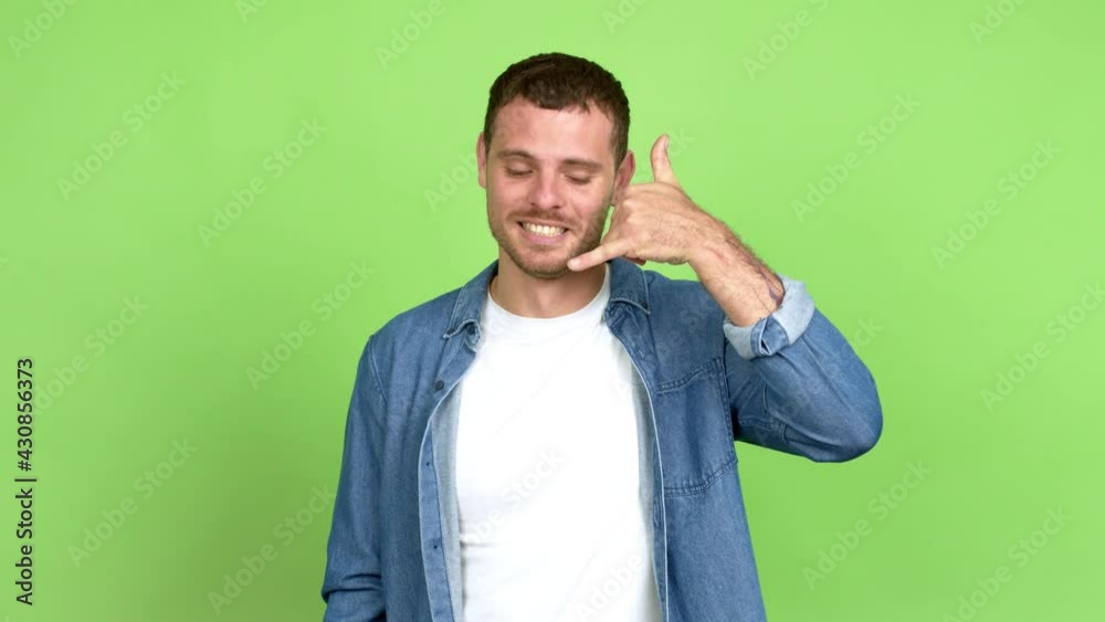 Brazilian handsome man making phone gesture and speaking with someone. Call me back sign over isolated background Brazilian handsome man making phone gesture and speaking with someone. Call me back sign over isolated background
