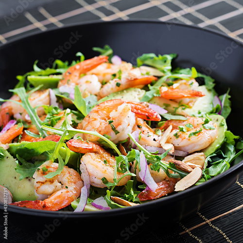 Salad of prawns. Salad of shrimps, arugula, avocado slice, red onion and almond nuts. Healthy concept.