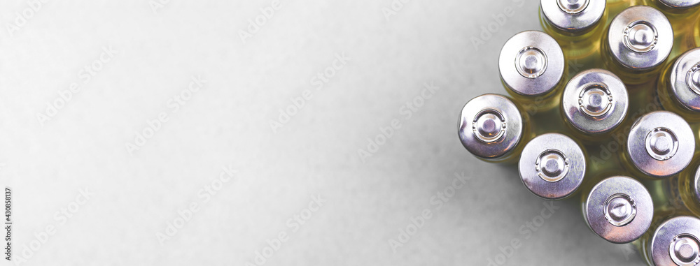 Development and manufacture process of covid-19 vaccine, coronavirus vaccine vials on the the white table background, banner with copy space, top view photo Development and manufacture process of covid-19 vaccine, coronavirus vaccine vials on the the white table background, banner with copy space, top view photo