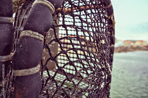 Primerísimo primer plano de una nasa para la pesca de langosta almacenada en un puerto de Galicia, España
 photo