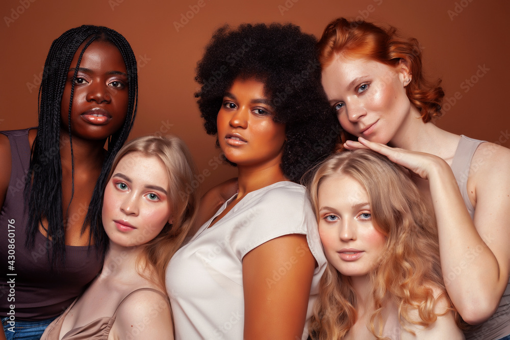 young pretty caucasian, afro, scandinavian woman posing cheerful together on brown background, lifestyle diverse nationality people concept young pretty caucasian, afro, scandinavian woman posing cheerful together on brown background, lifestyle diverse nationality people concept