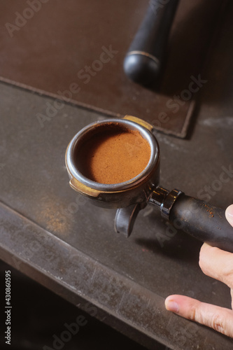 hand holding cafe preparing to make an espresso