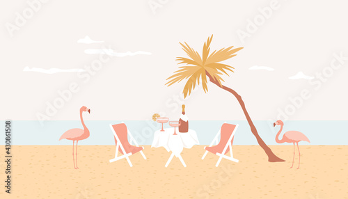 Romantic meal on the beach, flamingo, palm tree and table with champagne bottle, cocktail glasses. Honeymoon, luxury rest, solitude vacation concept. Seaside restaurant, paradise resort.