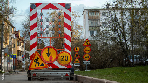 road signs warning about road repair and danger