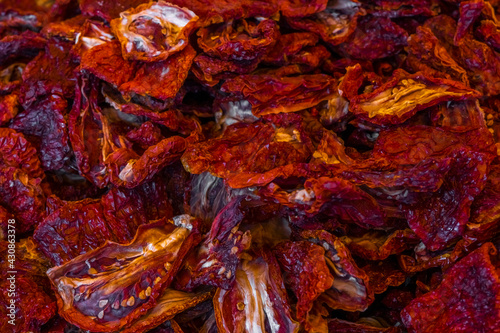 Dried red ripe tomatoes of counter for sale at vegetable market. Traditional Italian dried red tomatoes as background